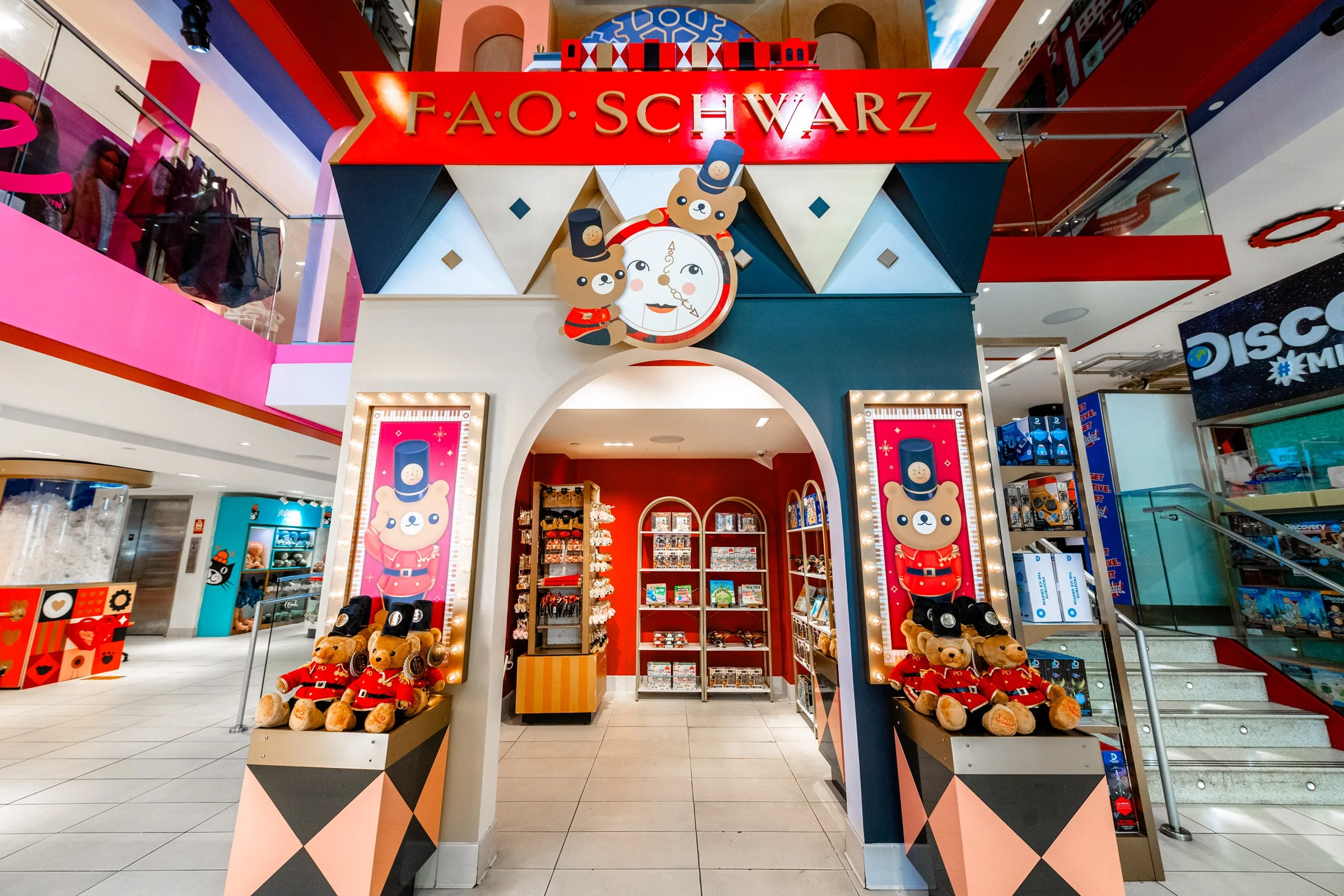 Colorful FAO Schwarz store entrance with plush toy displays and playful decor inside a shopping mall