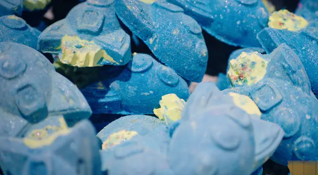 Close-up of blue bath bombs with yellow accents.