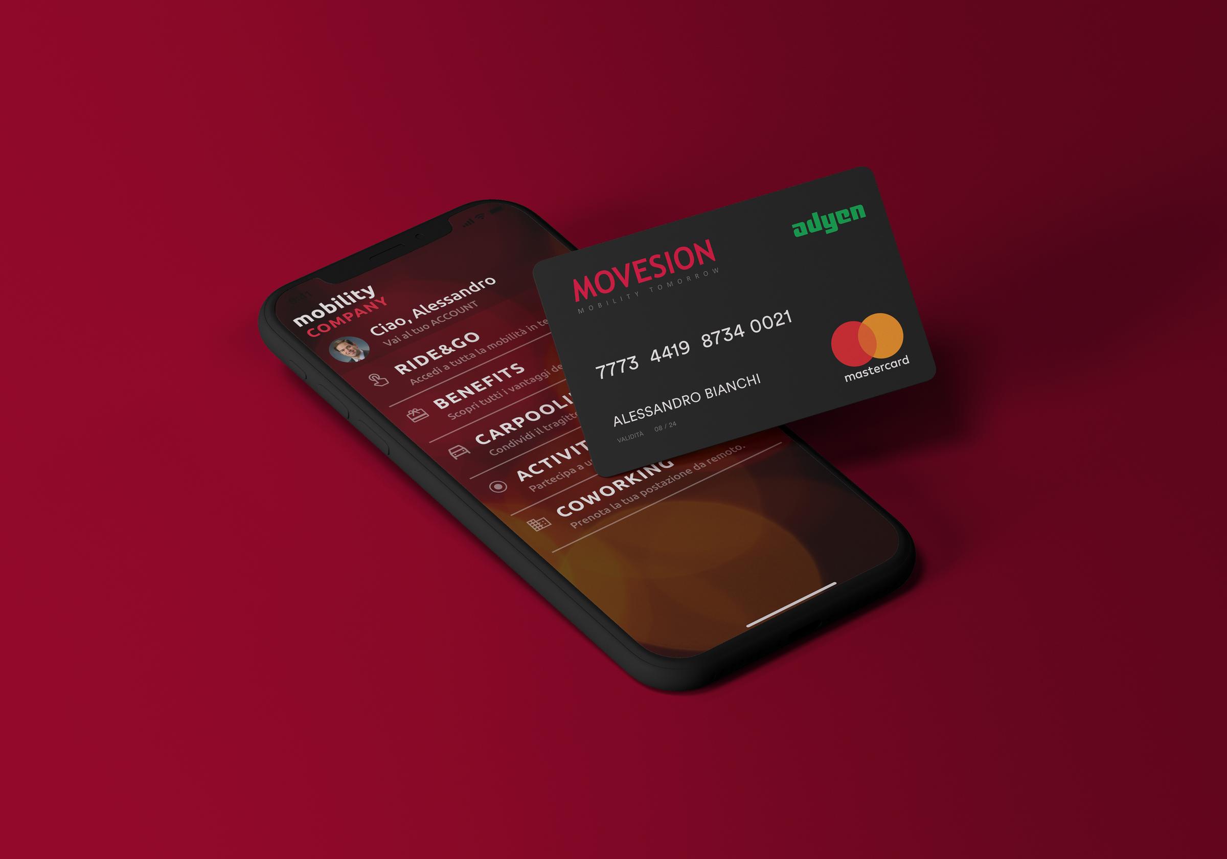 Smartphone che visualizza l'app di pagamento Adyen accanto a una Mastercard con logo Adyen su sfondo rosso