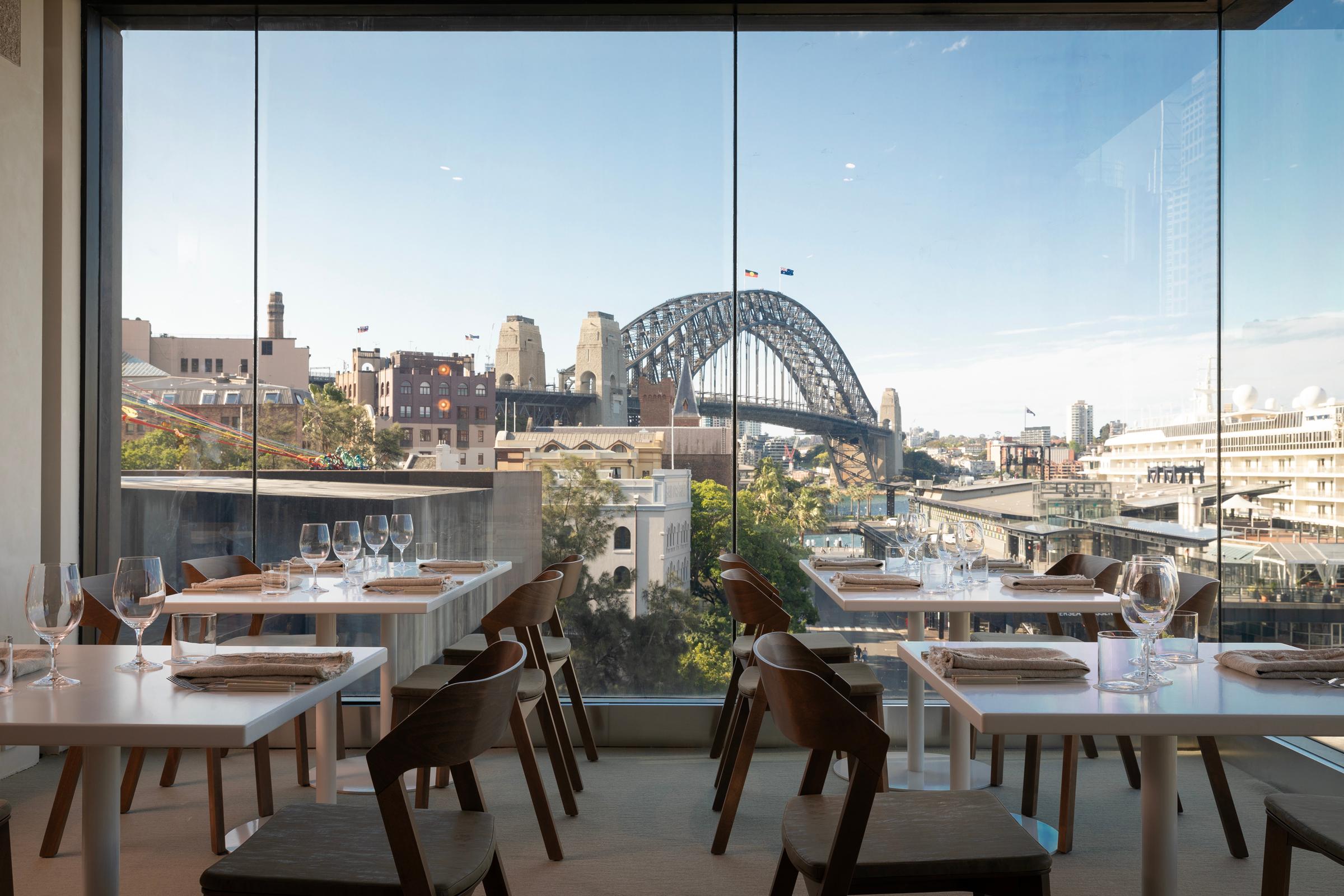A restaurant with a view to the Sydney harbor bridge in the back