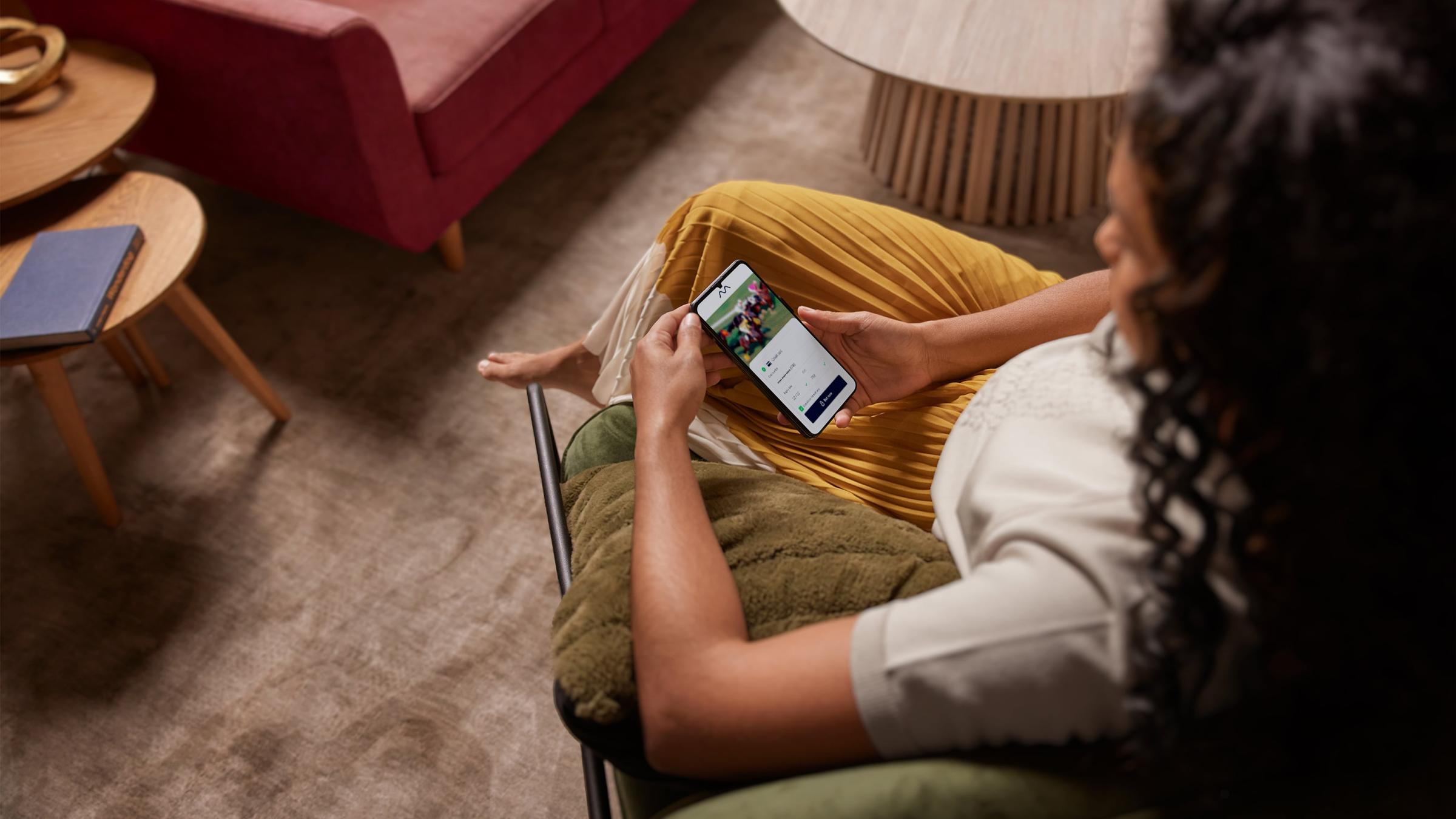 Woman on her phone placing a bet