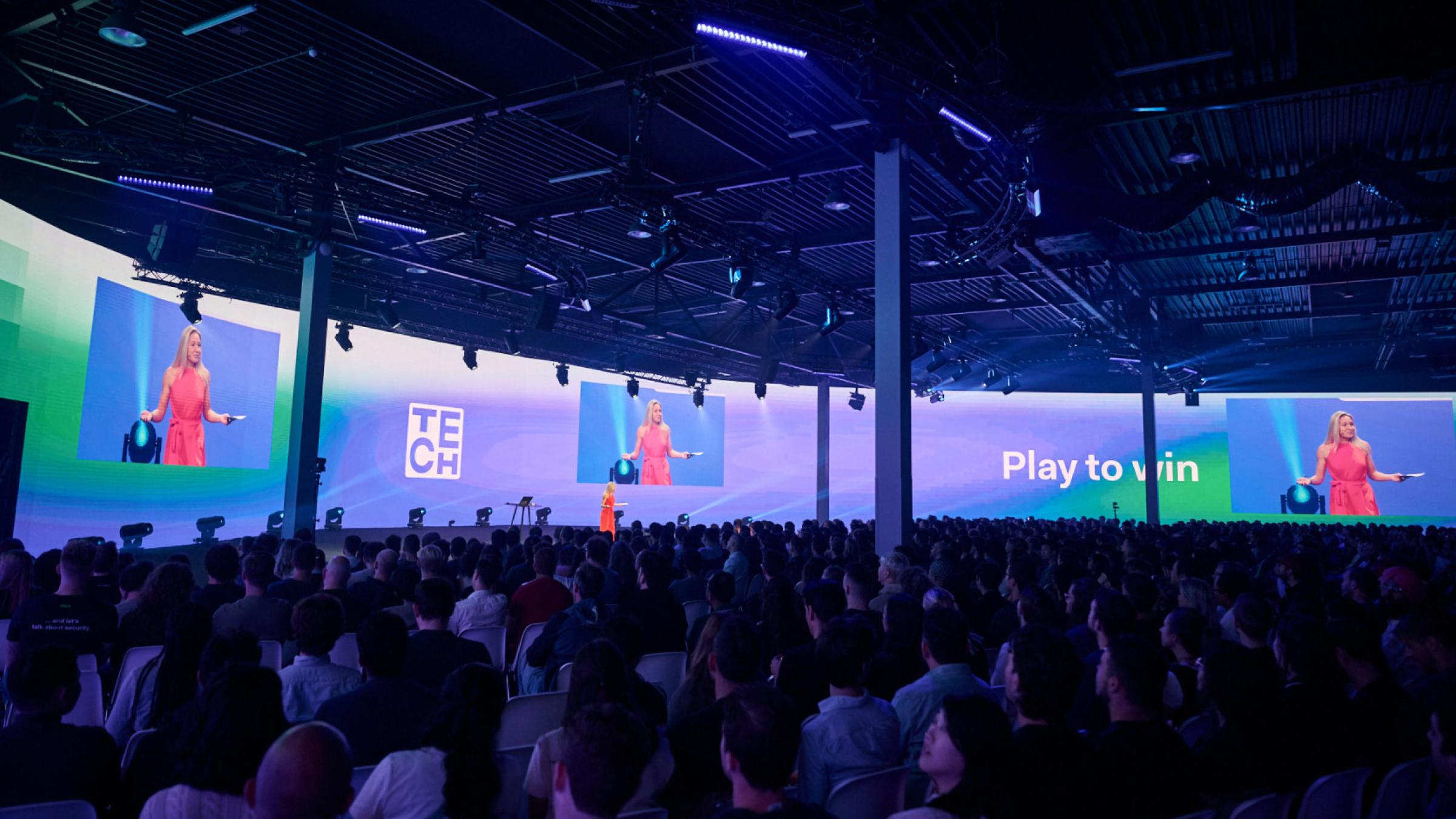 Danielle speaking on a stage of Adyen's Tech Event