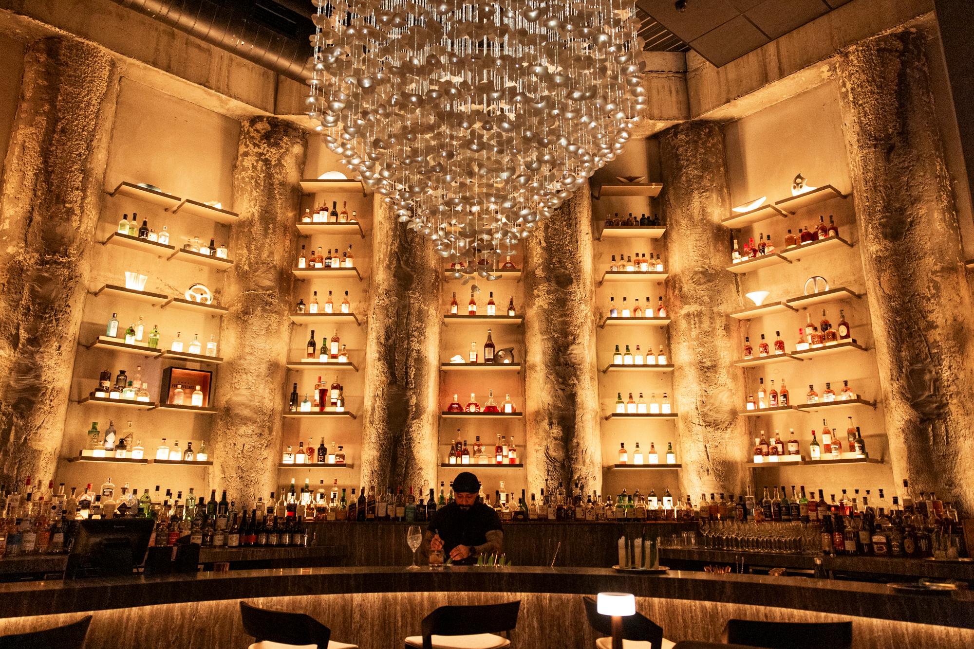 dimly lit bar with chandelier