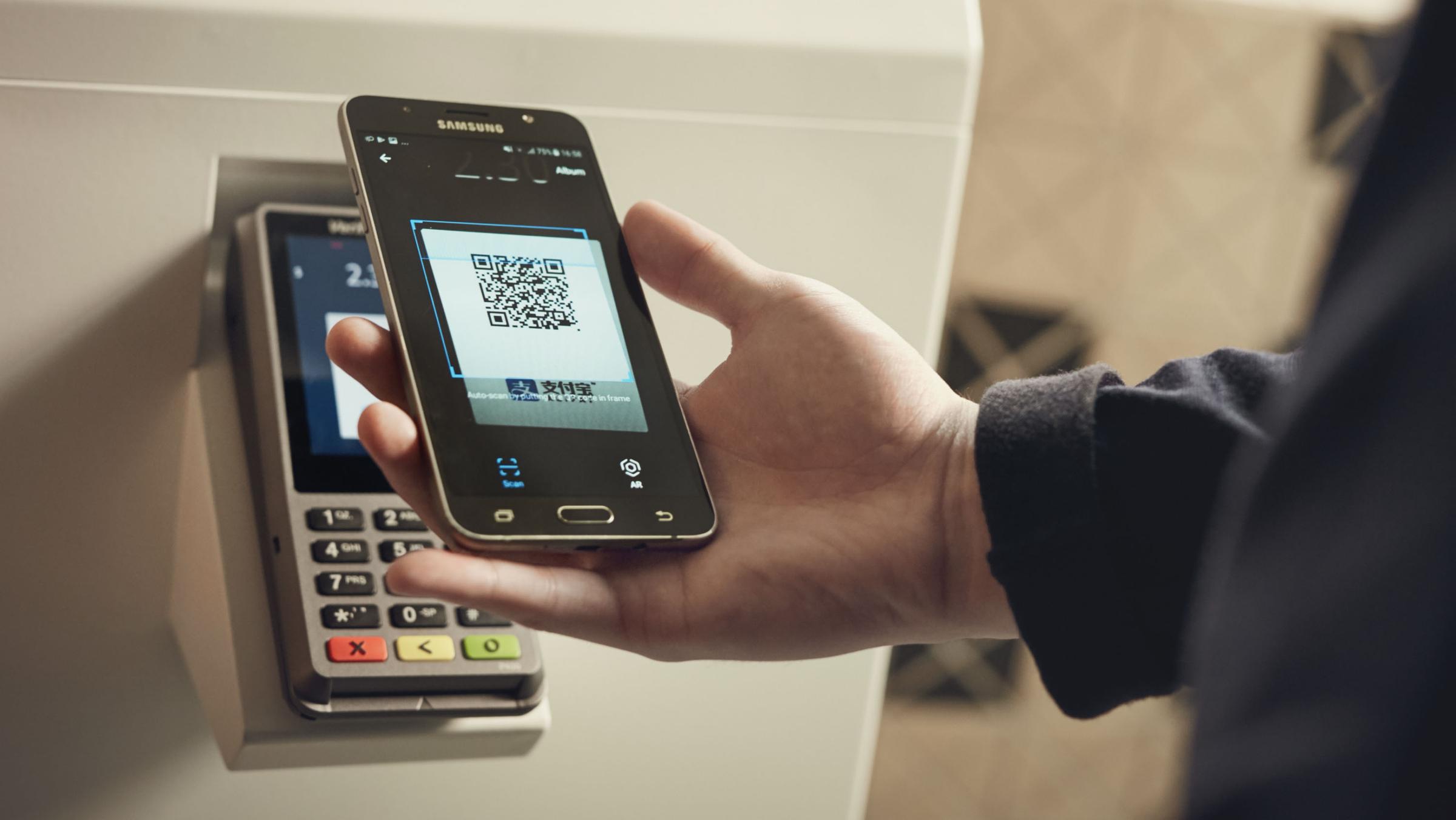 Phone scanning QR code from Ailpay