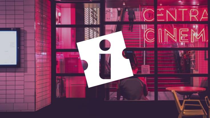 Entrada do Central Cinema com letreiro neon e silhueta de pessoa sentada à mesa