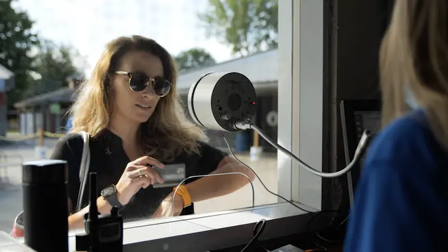 Customer using a card for contactless payment at an Adyen terminal.