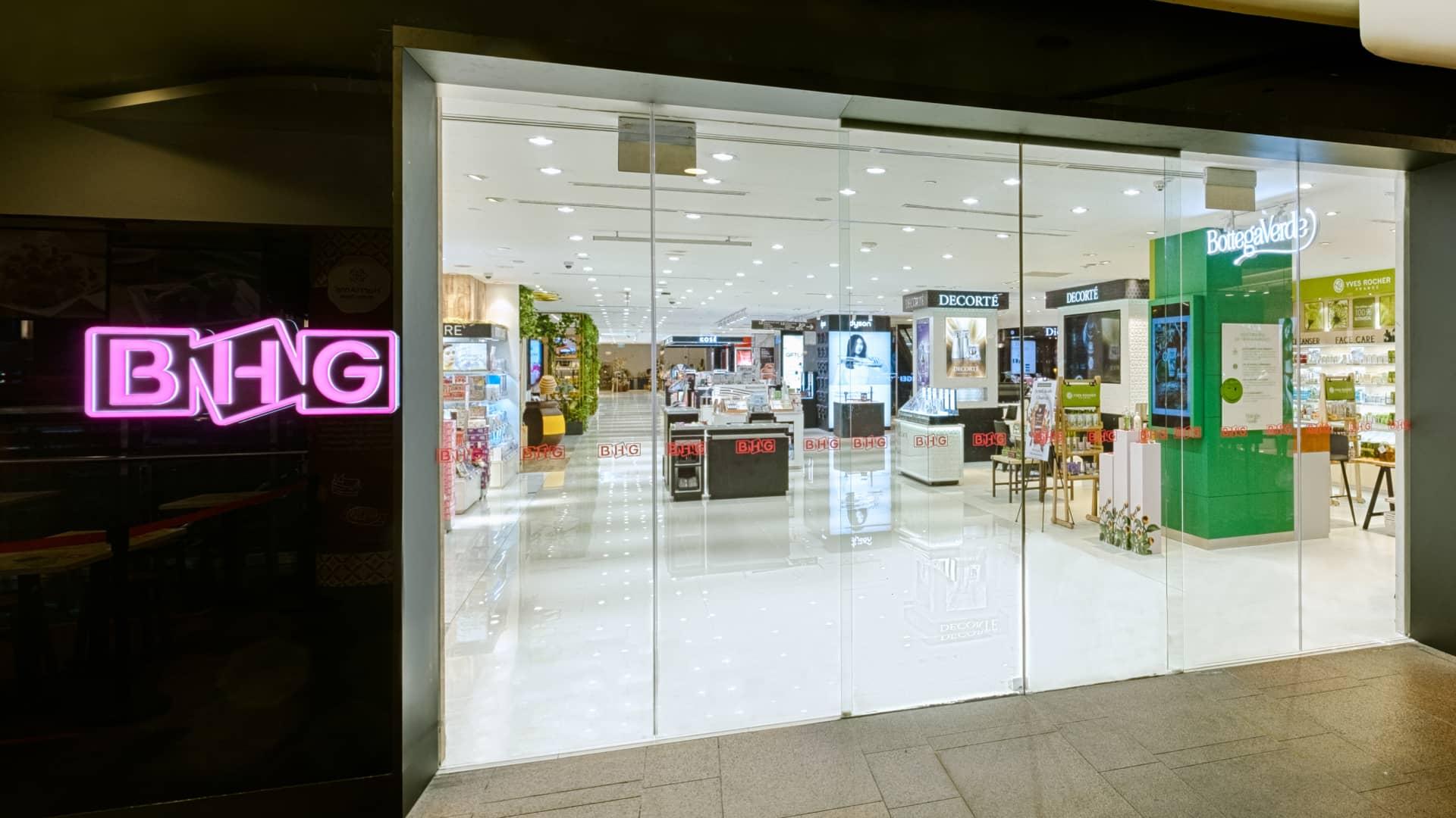BHG department store entrance with neon sign.