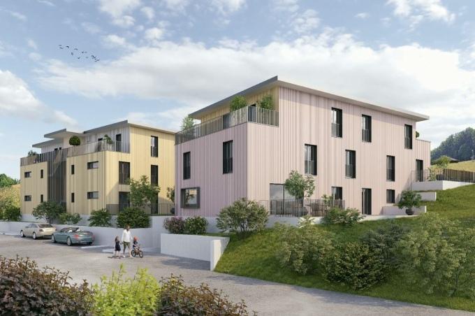 2 Mehrfamilienhäuser mit Eigentumswohnungen und Parkplatz. 1 Mehrfamilienhaus mit gelber Fassadenfarbe und 1 Mehrfamilienhaus mit roter Fassadenfarbe am Ischlagweg in Gelterkinden