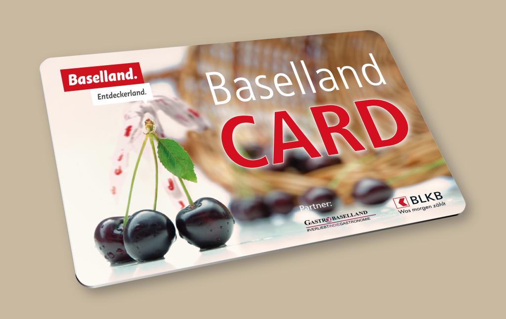 Kirschen neben einem Wasserfall, daneben die Bezeichnung Baselland Card.
