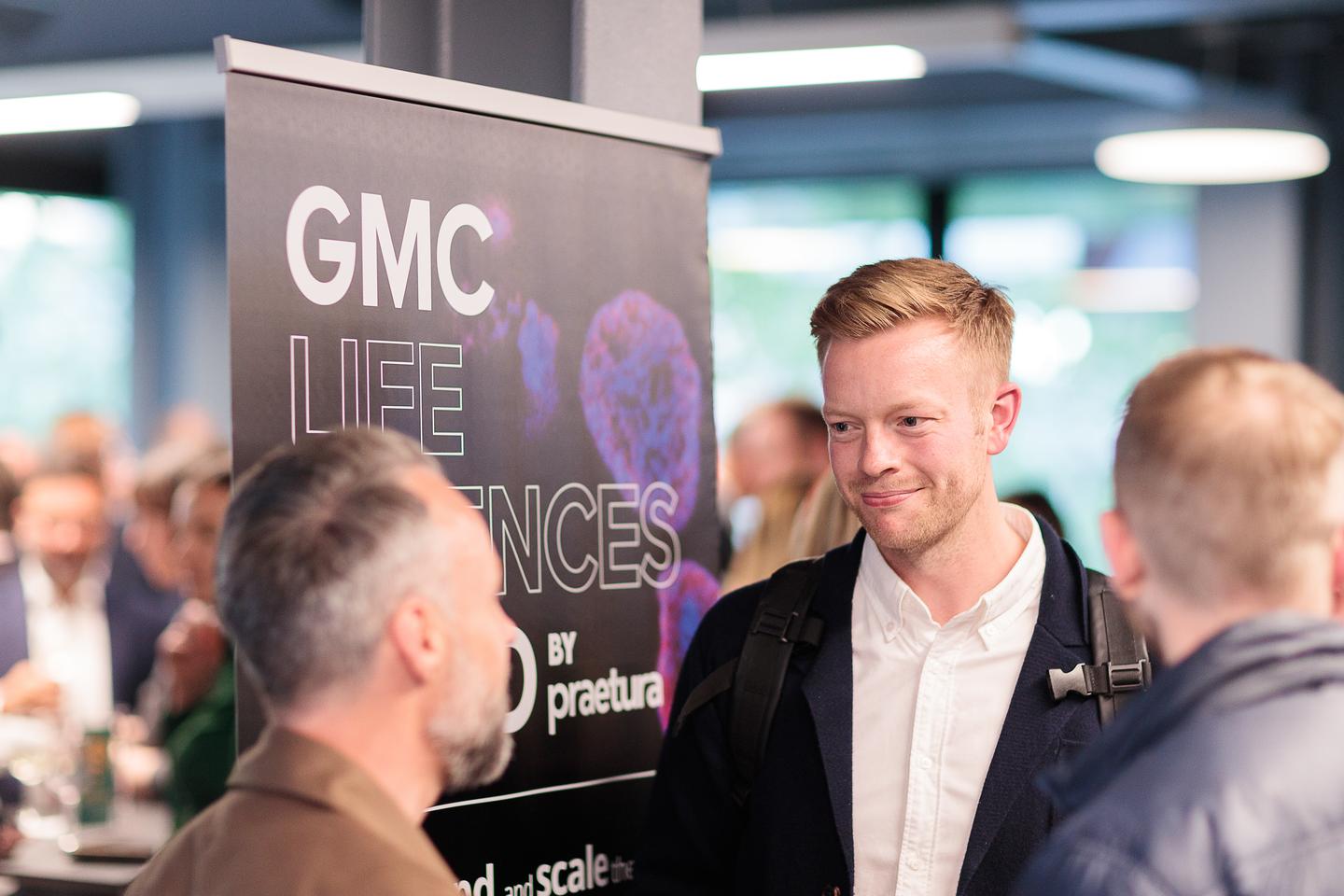 people chatting at science funding event