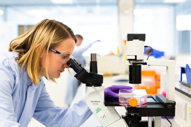A woman in a lab working with equipment