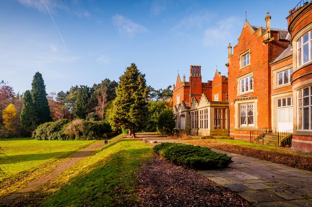 Exterior view of Abney Hall, with grounds to the left