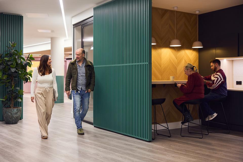 Customer walking up to reception desk at Mereside, Alderley Park