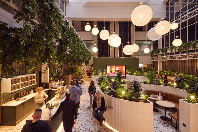 modern open work space in office building in birmingham with cafe and people ordering drinks and sitting down