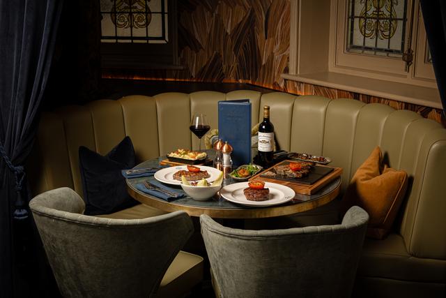 a table in a Cut & Craft restaurant with food and wine on at Bruntwood SciTech's Bond