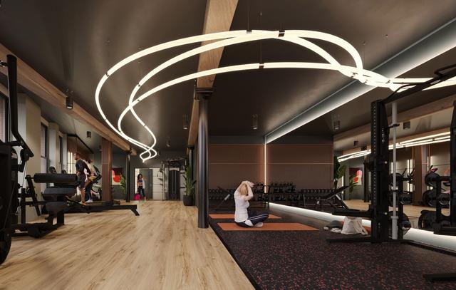 A CGI image of a woman sat on the floor of a gym space, stretching