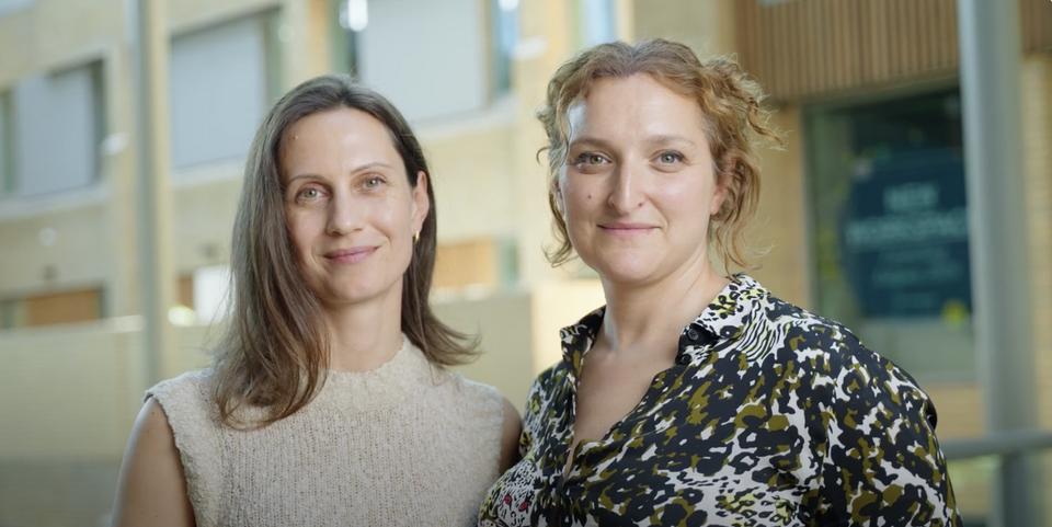 two women smiling into camera 