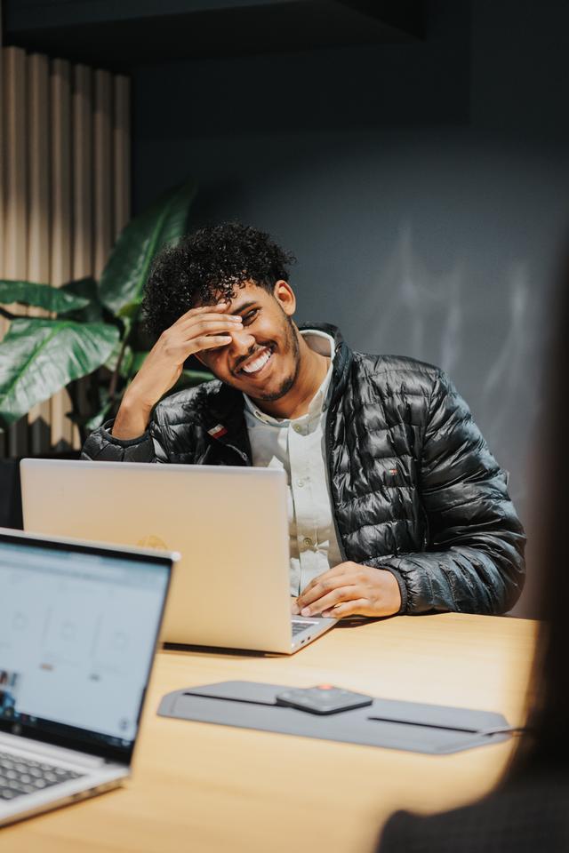 Happy worker smiling when in conversation with colleagues