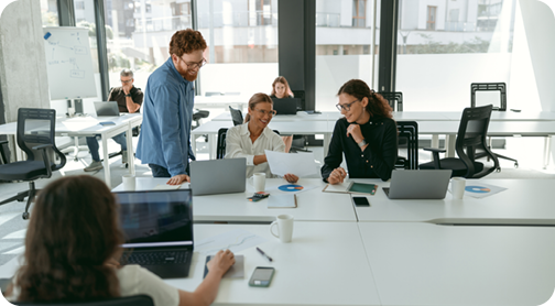 People in office using computers and smiling