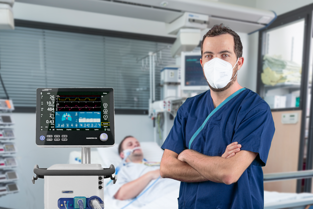Infirmier et patient près du ventilateur USI HAMILTON-C6