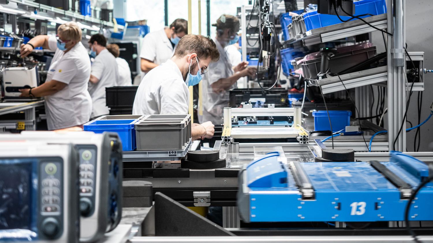 Employees put a ventilator together