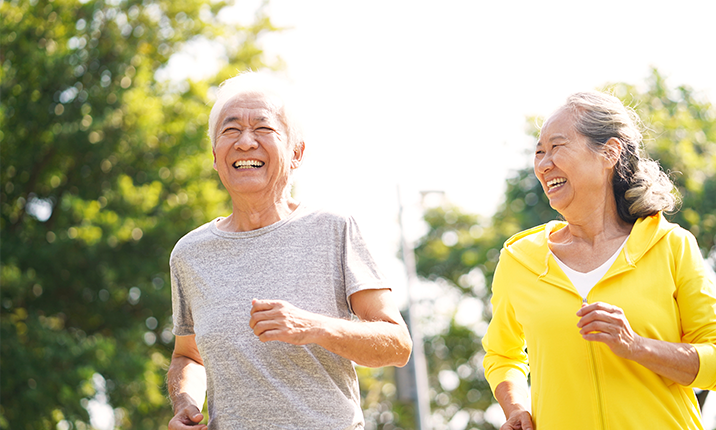 Happy Asian Senior Couple Running Exercising