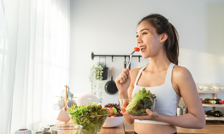 asian attractive sport woman holding salad
