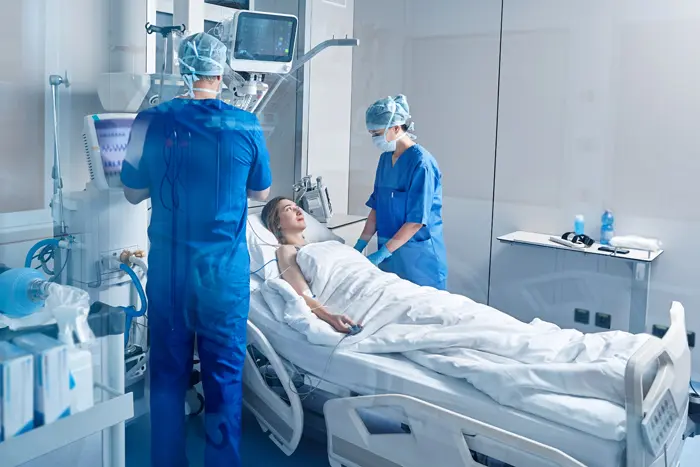 A patient smiling gratefully at the ICU nurses as she is being treated for an infection