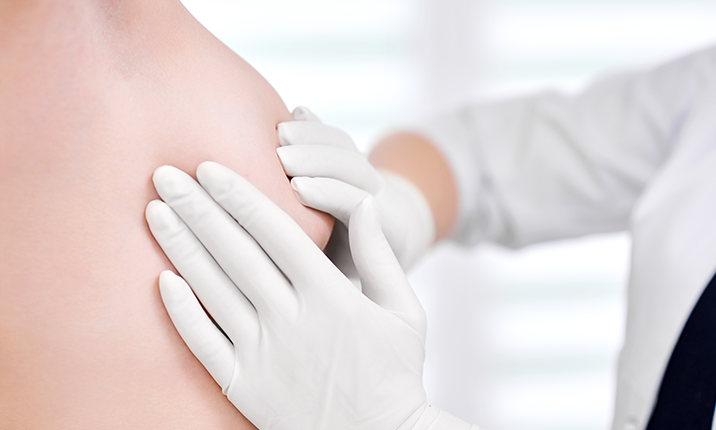 Young woman getting breast examination