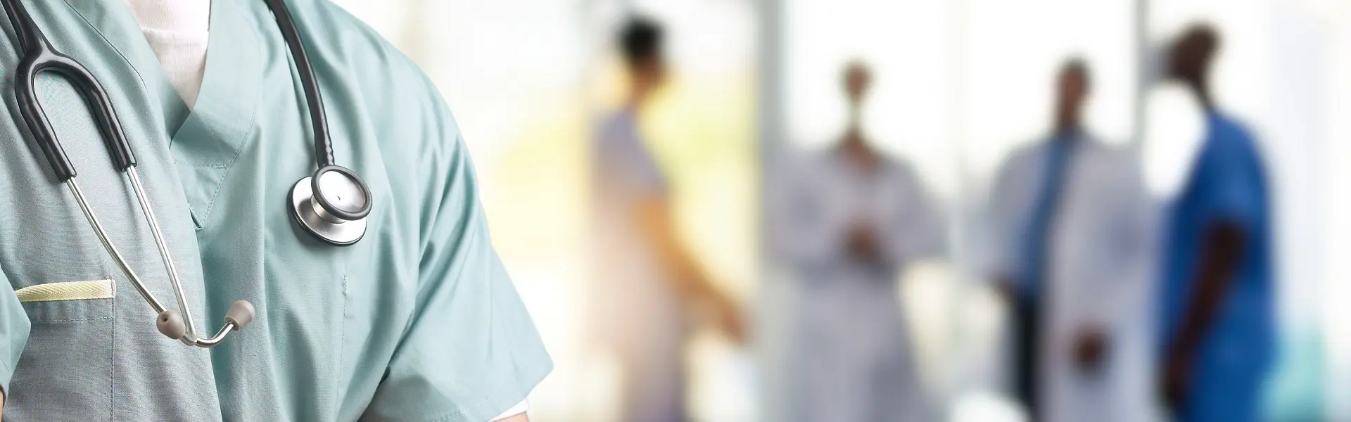 A surgeon in scrubs stands in the foreground, while four other doctors engage in a discussion in the background