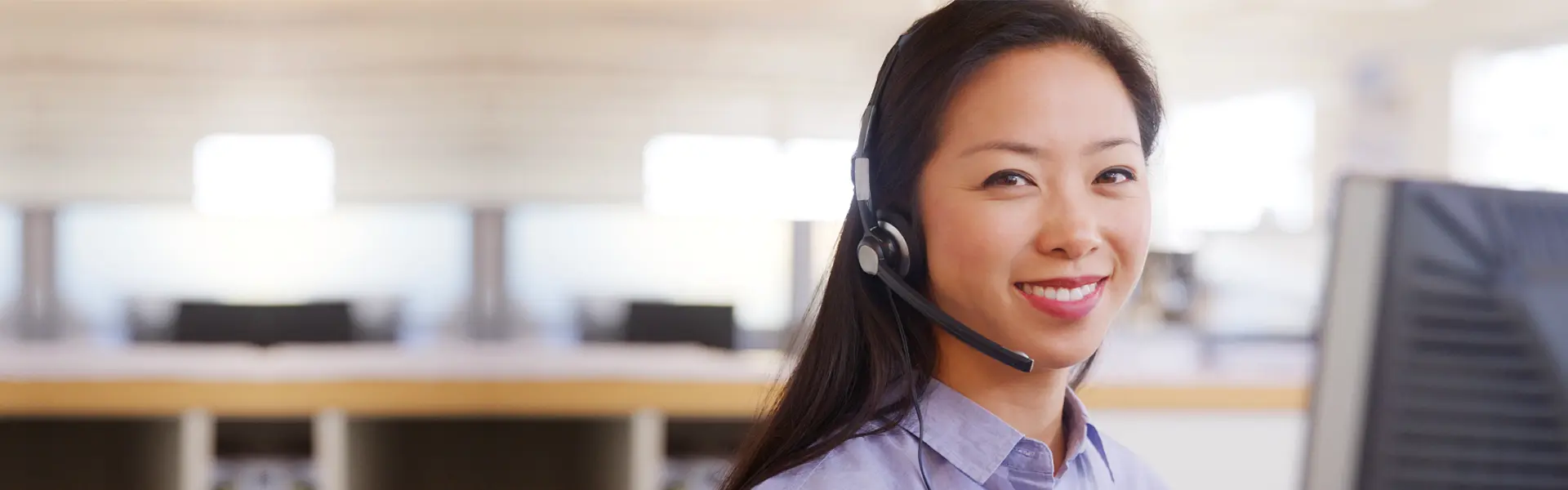 A smiling customer service lady wearing a headset