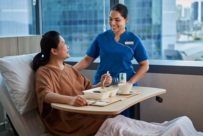 Lady on hospital bed with nurse