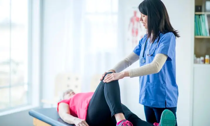 Woman having physiotherapy for hip fracture
