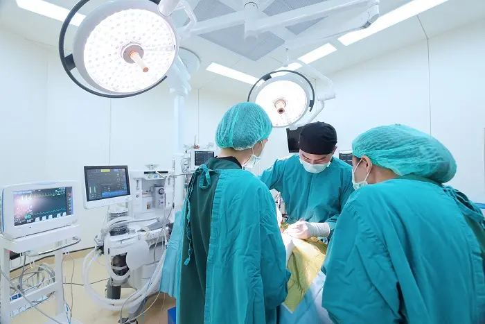 A group of surgeons performing general surgery on a patient