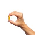 Woman’s hand holding Metagenics Inflavonoid Intensive Care® capsule. 