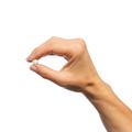 Woman’s hand holding Metagenics Cholarest® SC tablet.