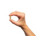 Woman’s hand holding Metagenics Concentrated Ultra Prostagen™ capsule.