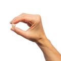 Hand holding Metagenics Adrenogen®, capsule.