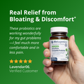 Customer testimonial for UltraFlora® Complete from Lavendar06, stating the probiotics improved bloating and gut discomfort. The product bottle is shown being held in one hand with a green background.