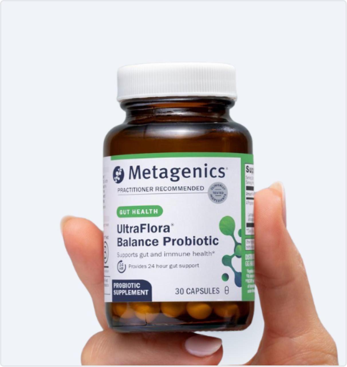 Metagenics UltraFlora Balance Probiotic bottle held in hand, shown on the Black Friday page to highlight gut and immune health support.