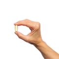 Woman’s hand holding Metagenics OmegaGenics® Borage Seed GLA Oil 240 mg softgel. 