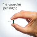 Hand holding a green capsule, indicating a recommended dosage of 1-2 capsules per night for restful sleep.