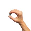 Woman’s hand holding Metagenics Insulin Guard tablet.