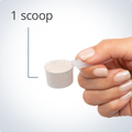Hand holding a scoop of Glutagenics® powder, indicating a recommended serving size of one scoop per day.