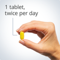 Hand holding a yellow Ostera® tablet with recommended dosage instructions.