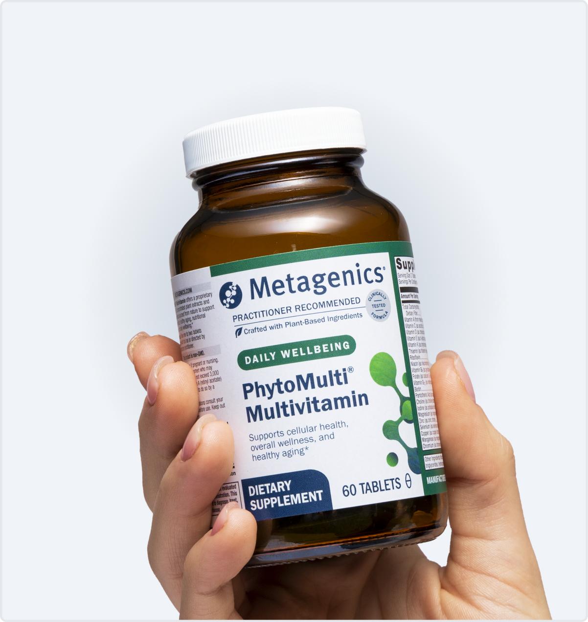 Metagenics PhytoMulti Multivitamin bottle held in hand, shown on the Black Friday page to promote daily wellness and immune support.