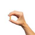 Woman’s hand holding Metagenics Ceralin® capsule. 