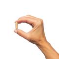 Hand holding a single AdvaClear® capsule, highlighting the compact and convenient size for daily use.