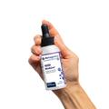 Woman’s hand holding Metagenics BioSom® bottle. 