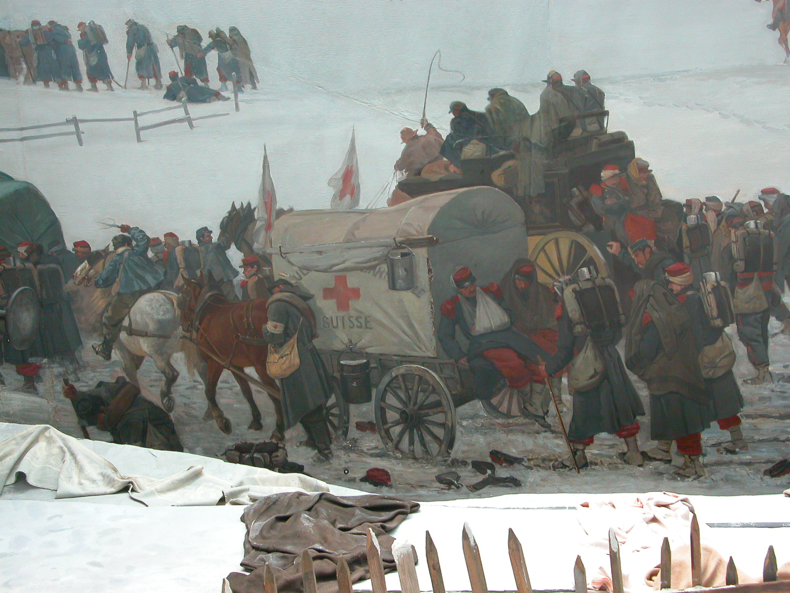 Extrait du tableau "Panorama Bourbaki". On y voit une voiture avec des chevaux attelés devant, des blessés à l'arrière.